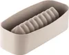 A silicone mold for baking in the shape of a log or loaf, placed inside a beige rectangular container. Produktbild-Vorschau