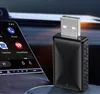 A black USB adapter is plugged into a car's infotainment system, which displays app icons. Podgląd zdjęcia produktu