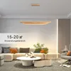 A modern living room with a sectional sofa, coffee table, and a pendant light. Voir les images du produit