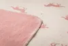 A close-up view of a pink blanket with a pattern of pink horses. Náhľad obrázku produktu