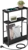 A narrow black side table with a charging station, a tablet, a digital clock, and a small plant. Produktbild-Vorschau