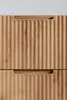 Close-up of two wooden drawers with ribbed fronts and cut-out handles. Produktbild-Vorschau