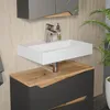 A modern bathroom vanity with a sink and faucet, featuring a plant in the background. Náhled obrázku produktu