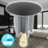 A bathroom drain stopper is shown in the foreground, with a blurred bathroom scene in the background. Produktbild-Vorschau