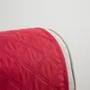 Close-up of a quilted red cushion edge with a gray trim. Produktbild-Vorschau