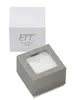 A white box with a logo and text, and a gray box with a clear window, both on a white background. Náhled obrázku produktu