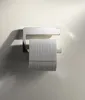 A chrome toilet paper holder mounted on a light-colored wall, with a roll of toilet paper on it. Anteprima dell’immagine prodotto