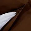A close-up view of a brown fabric with a zipper partially open, revealing a white mesh material underneath. Produktbild-Vorschau