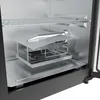 Close-up view of the interior of an electric smoker, showing the heating elements, a smoke generator, and a drip tray. Produktbild-Vorschau