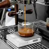 Espresso being brewed into a glass beaker on a scale. Produktbild-Vorschau