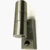 A modern outdoor wall light with a brushed metal finish, mounted on a white wall. Produktbild-Vorschau