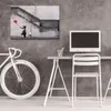 A modern office or studio space with a desk, computer, chair, and a bicycle. Podgląd zdjęcia produktu