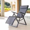 A gray reclining garden chair is shown on a patio with a blurred background of a modern house and greenery. Produktbild-Vorschau