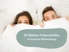 A couple in bed under the covers, with a promotional overlay. Produktbild-Vorschau