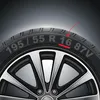 A close-up view of a car tire with markings indicating its specifications. Produktbild-Vorschau
