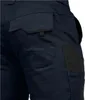 A close-up view of the back pockets of dark blue work pants with black accents. Produktbild-Vorschau