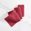 Three red kitchen towels are arranged on a white marble surface. Produktbild-Vorschau