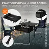 A camping table and chairs set up outdoors near a body of water. Produktbild-Vorschau