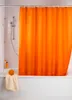 A bathroom scene with an orange shower curtain. Produktbild-Vorschau