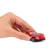 A hand holding a red toy car. Podgląd zdjęcia produktu