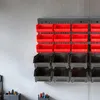 A wall-mounted storage system with red and black bins. Produktbild-Vorschau