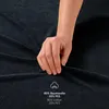 A hand is shown touching a dark blue fabric, with text overlay indicating the material composition. Voir les images du produit