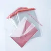 A stack of clear plastic bags with red sealing strips, one bag containing a red envelope, on a white background. Náhľad obrázku produktu