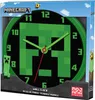 The image shows the packaging of a Minecraft wall clock. The clock face features a pixelated Creeper design with green hands and numbers on a black background. The packaging also includes Minecraft branding and illustrations of bees and clouds. Produktbild-Vorschau