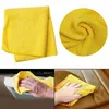 Collage showing a yellow microfiber cloth, close-up of the cloth's texture, and hands using the cloth to clean car interior and leather seats. Produktbild-Vorschau