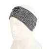A close-up of a grey and black heathered fabric headband with a small blue control module on the front, shown on a white mannequin head. Náhľad obrázku produktu