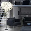A modern living room with a floor lamp, sofa, and stairs. Produktbild-Vorschau