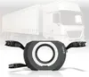 A product shot of a steering wheel accessory for a racing simulator, with a blurred truck in the background. Produktbild-Vorschau