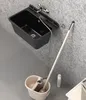 A black sink with a hose connected to a mop bucket, a mop, and a cleaning bottle. Náhled obrázku produktu