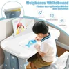 A young child is drawing at a child's desk with a whiteboard. Produktbild-Vorschau