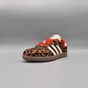 A single Adidas Samba OG shoe with a leopard print pattern is shown against a plain gray background. Podgląd zdjęcia produktu