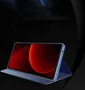 A tablet or phone in a blue case, displayed at an angle against a dark background with blue light streaks. Náhled obrázku produktu