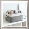 A storage basket filled with books on a shelf. Anteprima dell’immagine prodotto