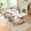A dining room scene with a marble-look table and chairs. Produktbild-Vorschau