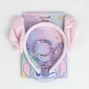 A Disney Lilo & Stitch Angel themed accessory set including a headband with ears and a necklace with beads and a charm, presented on its original packaging. Anteprima dell’immagine prodotto