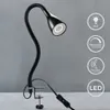 A black gooseneck desk lamp with a clamp base is shown against a plain gray background. Several circular icons with text and symbols are displayed to the right of the lamp. Anteprima dell’immagine prodotto