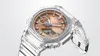 A close-up, studio shot of a transparent G-Shock watch with a rose gold face. Voir les images du produit