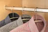 Three men's dress shirts hanging on hangers in a closet. Produktbild-Vorschau