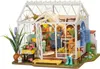 A miniature greenhouse model with detailed interior furnishings and plants. Anteprima dell’immagine prodotto