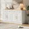 A white sideboard buffet with gold handles is shown in a well-lit room, with a lamp and artwork on top. A rug is on the floor in front of it. Anteprima dell’immagine prodotto