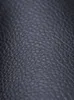 A close-up, detailed view of the textured surface of black faux leather. Podgląd zdjęcia produktu
