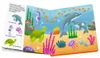 An open children's book showing an underwater scene with various sea creatures and text labels. Produktbild-Vorschau