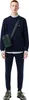 A man wearing a blue sweatshirt and pants, with a green bag slung across his chest. Anteprima dell’immagine prodotto