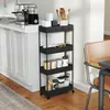 A black four-tier rolling cart filled with various kitchen items, placed next to a kitchen counter with appliances and cabinets. Voir les images du produit