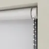 Close-up of a white roller blind mechanism with a beaded pull cord. Produktbild-Vorschau