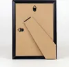 The back of a black picture frame with a stand. Produktbild-Vorschau
